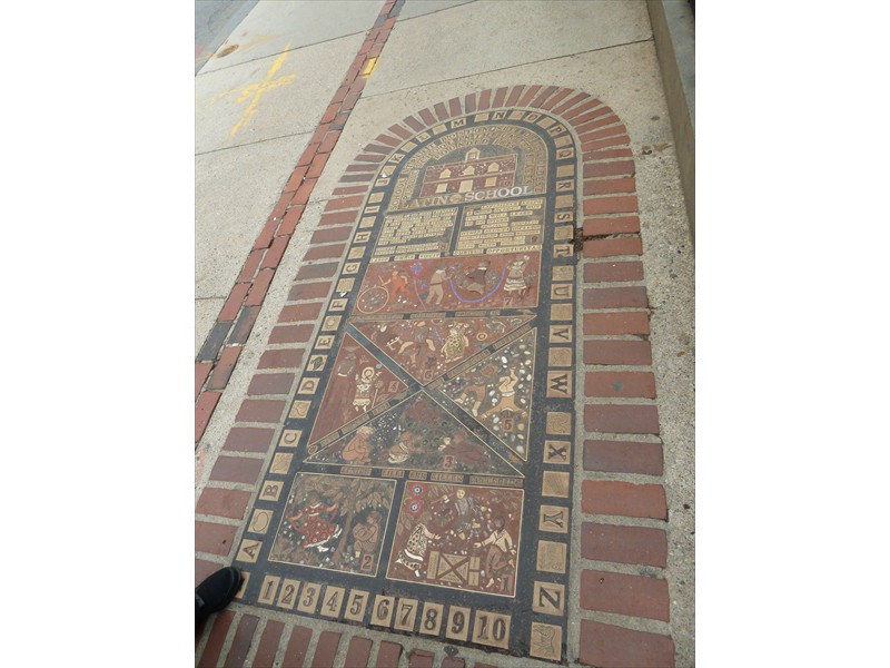 Latin School mosaic embedded in the sidewalk